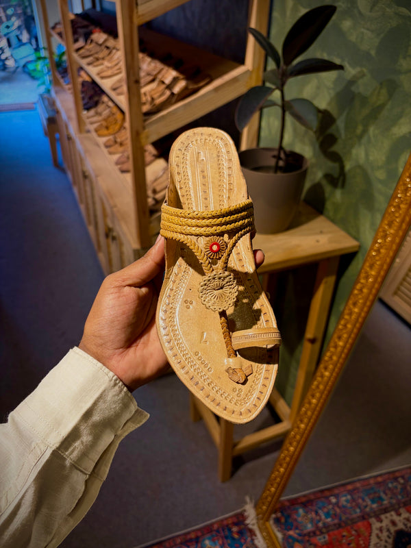 Authentic traditional Kolhapuri chappal for women handmade leather footwear unique design held in hand top angle view