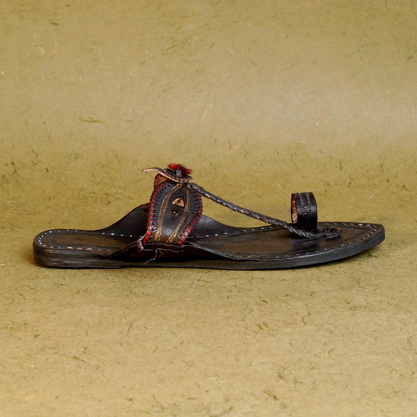 Side view women’s authentic Dola Patta Kolhapuri chappal, handcrafted leaf-pattern leather traditional ethnic comfortable sandal design.